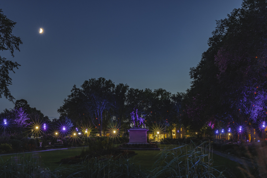 Jardin Jeanne-d'Arc illuminé et teinté de jaune et de mauve en soirée